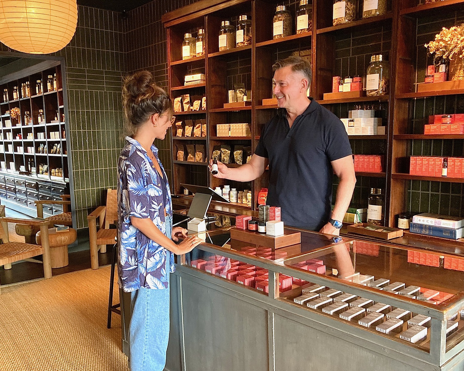 Dragon Hemp Apothecary owner Kevin Menard explains how his products work to a customer at his Main Street store in Sag Harbor. KYRIL BROMLEY