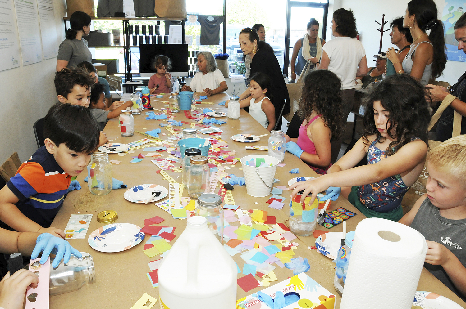 On August 15, The Concerned Citizens of Montauk showed their concern for ecology with a combined outdoor and indoor event...a kids beach cleanup and an art project. The first task was to gather discarded plastic litter items from the ocean beach behind the CCOM office into a custom CCOM canvas bag, followed by a creative art project at a communal table in the office, where the items were reused to make imaginative jars for the participants to take home.    RICHARD LEWIN