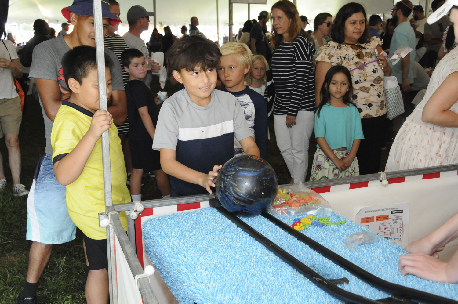 The East Hampton Library hosted its annual Children's Fair in Herrick Park on Sunday The weather was perfect for a huge assortment of amusement park rides, a crazy magic show, arts and crafts and carnival games. Families had the opportunity to meet authors of their favorite books in person. The line at the free ice cream truck was endless.   RICHARD LEWIN