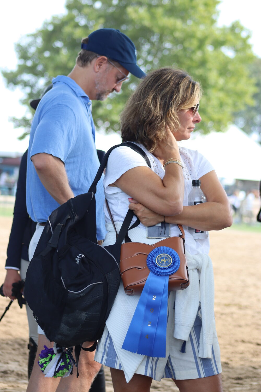 The ultimate handbag accessory: a blue ribbon. CAILIN RILEY