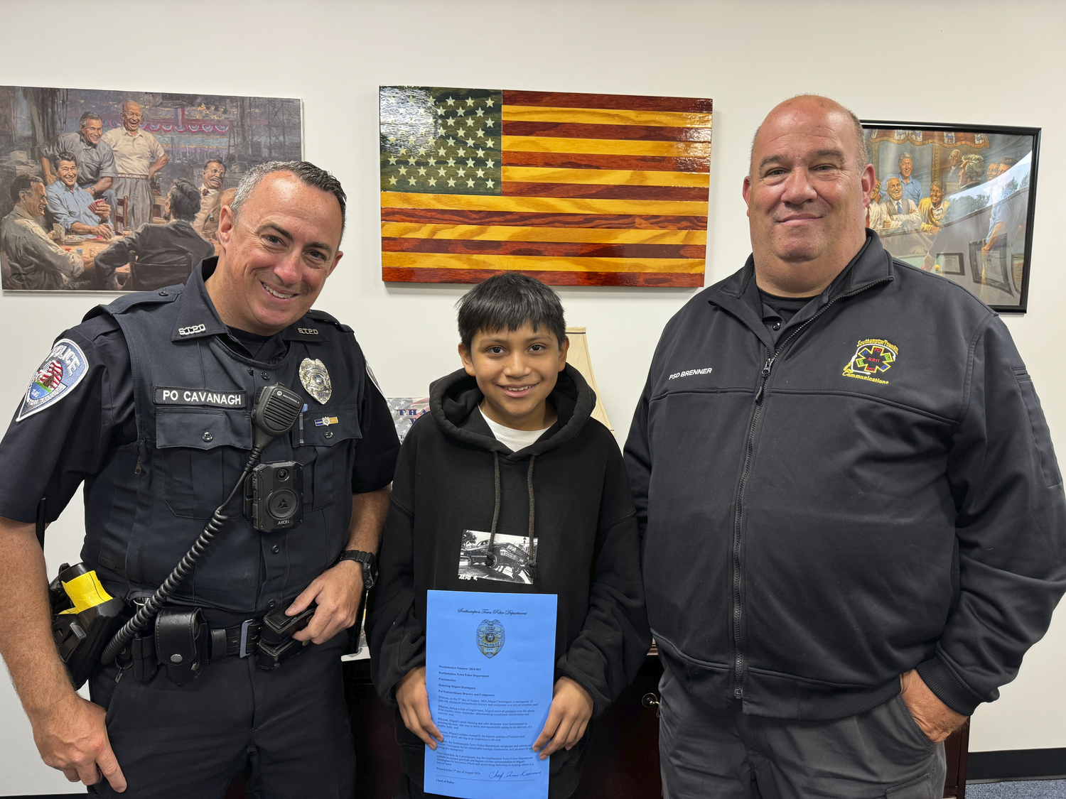 Southampton Town Police Officer James Cavanagh,12-year-old Miguel Dominguez and Southampton Town Public Safety Dispatcher Chris Brenner.   MICHAEL WRIGHT