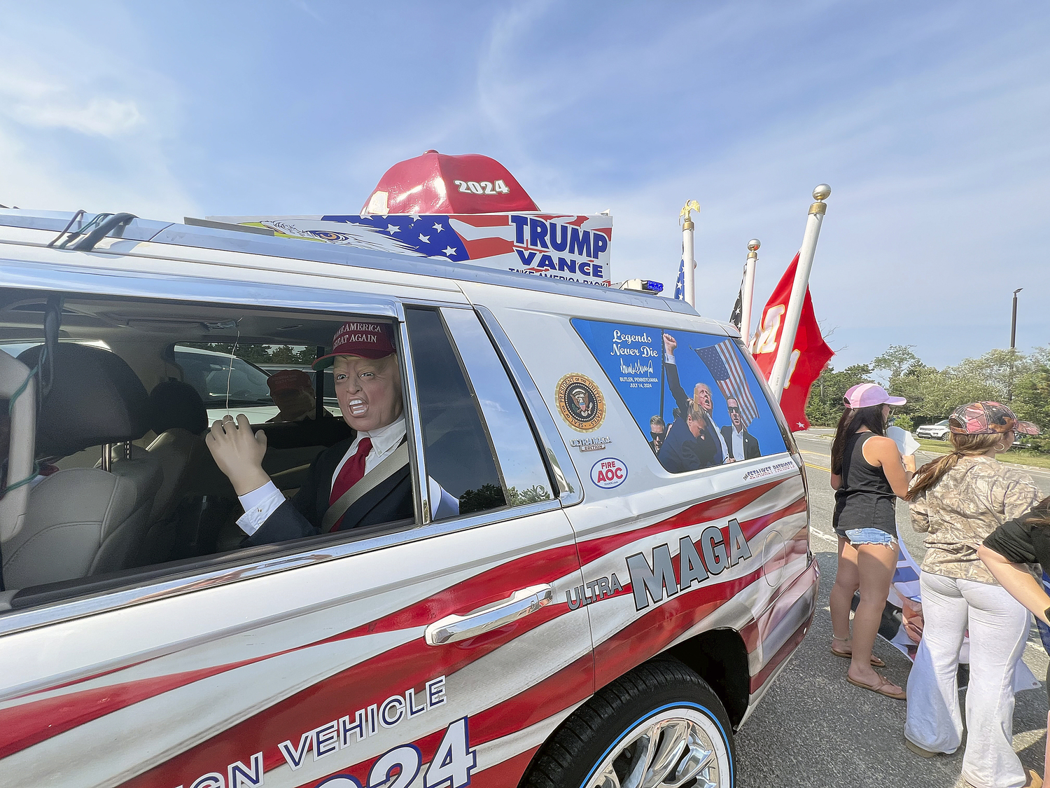 Supporters of former President Donald Trump lined a portion of Old Riverhead Road near Gabreski Airport in Westhampton Beach, waiting for hours to catch a glimpse of the passing motorcade. The former President's visit to the Bridgehampton home of Cantor Fitzgerald CEO Howard Lutnick for a campaign fundraiser. The visit brought traffic to a standstill across the east end for hours on Friday evening.  DANA SHAW