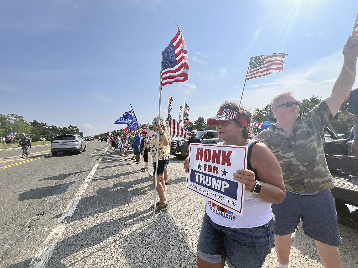 Supporters of former President Donald Trump lined a portion of Old Riverhead Road near Gabreski Airport in Westhampton Beach, waiting for hours to catch a glimpse of the passing motorcade. The former President's visit to the Bridgehampton home of Cantor Fitzgerald CEO Howard Lutnick for a campaign fundraiser. The visit brought traffic to a standstill across the east end for hours on Friday evening.  DANA SHAW