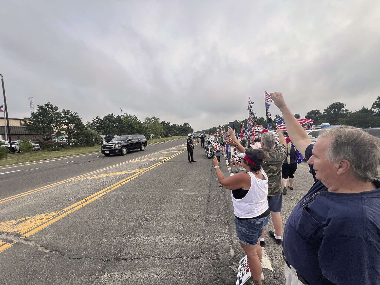 Supporters of former President Donald Trump lined a portion of Old Riverhead Road near Gabreski Airport in Westhampton Beach, waiting for hours to catch a glimpse of the passing motorcade. The former President's visit to the Bridgehampton home of Cantor Fitzgerald CEO Howard Lutnick for a campaign fundraiser. The visit brought traffic to a standstill across the east end for hours on Friday evening.  DANA SHAW