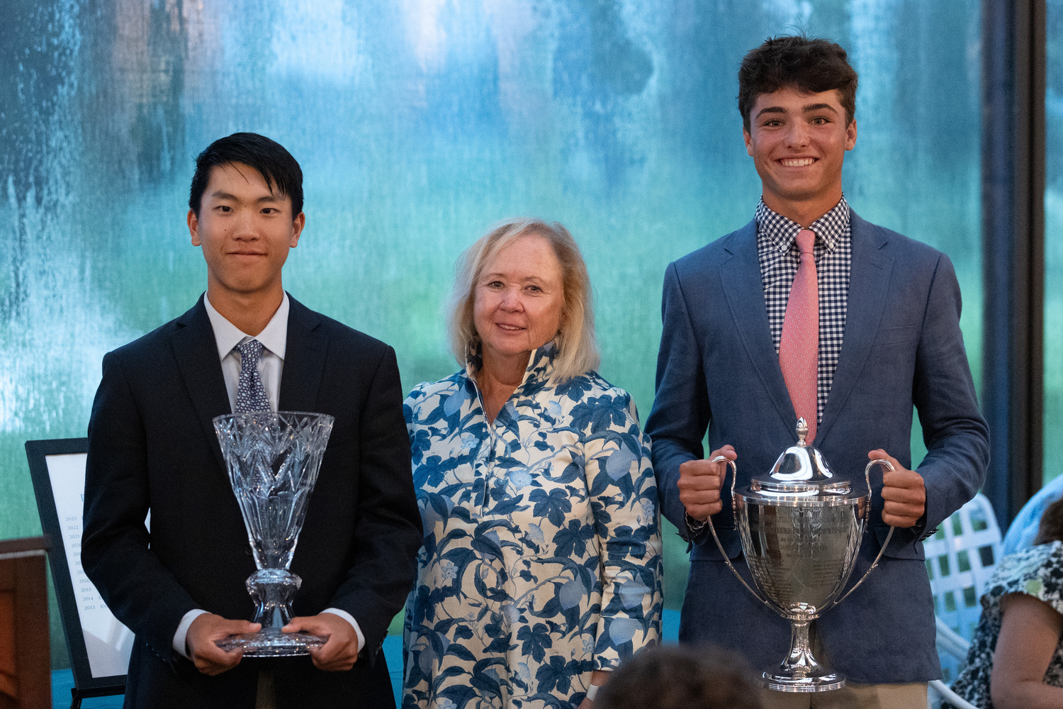 Jack Chung, left, Mary Lou Carter, mother of the tournament’s namesake, and Owen Jessop holding up the Carter Cup trophy.  METROPOLITAN GOLF ASSOCIATION