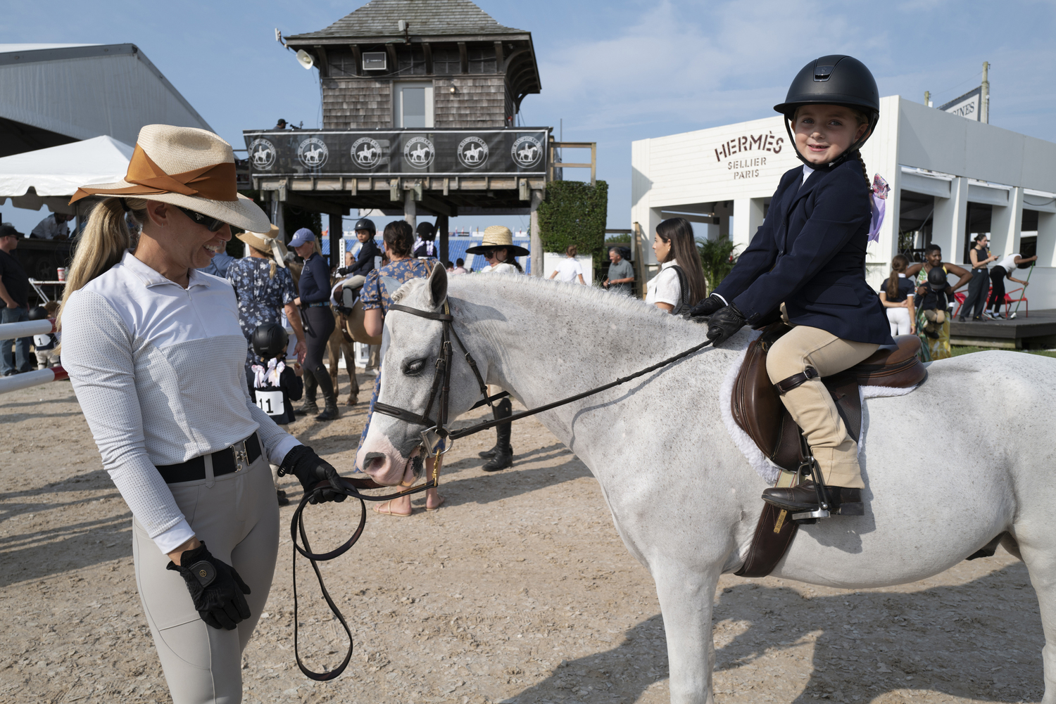 Ava Tadross with her trainer Jess Santolaya on her mount Jet Puffed, after a great performance in the leadline.   LORI HAWKINS