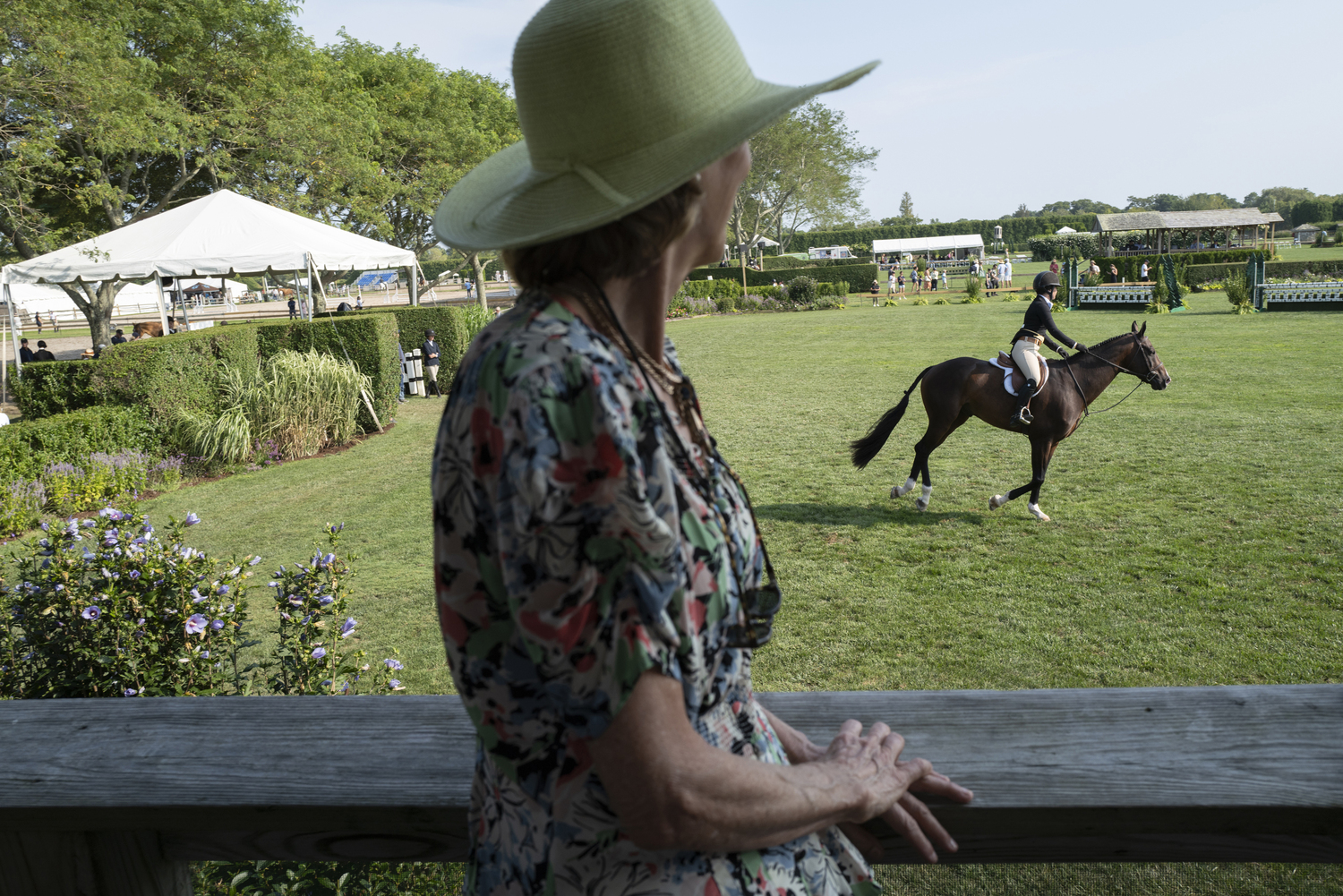 Nancy Marder Banfield looks in at one of the rings at The Hampton Classic on Sunday.   LORI HAWKINS