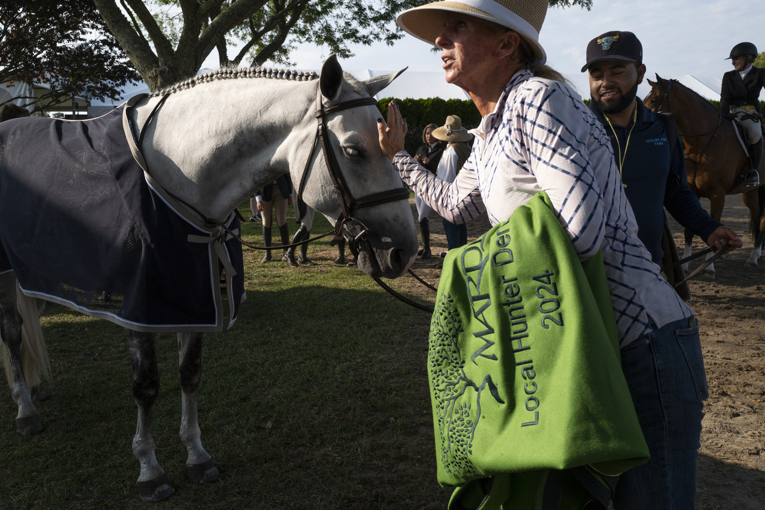 Jenn Bowery of Oceans Edge Farm with Addison Litman's horse, Cloud 9, after Laura Bowery won the the $10,000 Marder's Local Hunter Derby on him on Sunday.   LORI HAWKINS