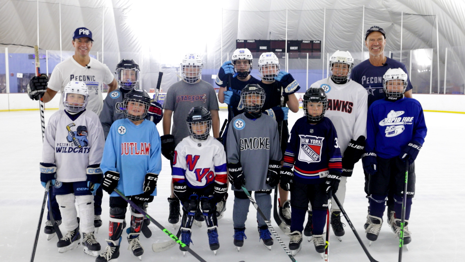 Players of Peconic Hockey with Mark Messier and Troy Albert.    COURTESY JIM TAMBURINO