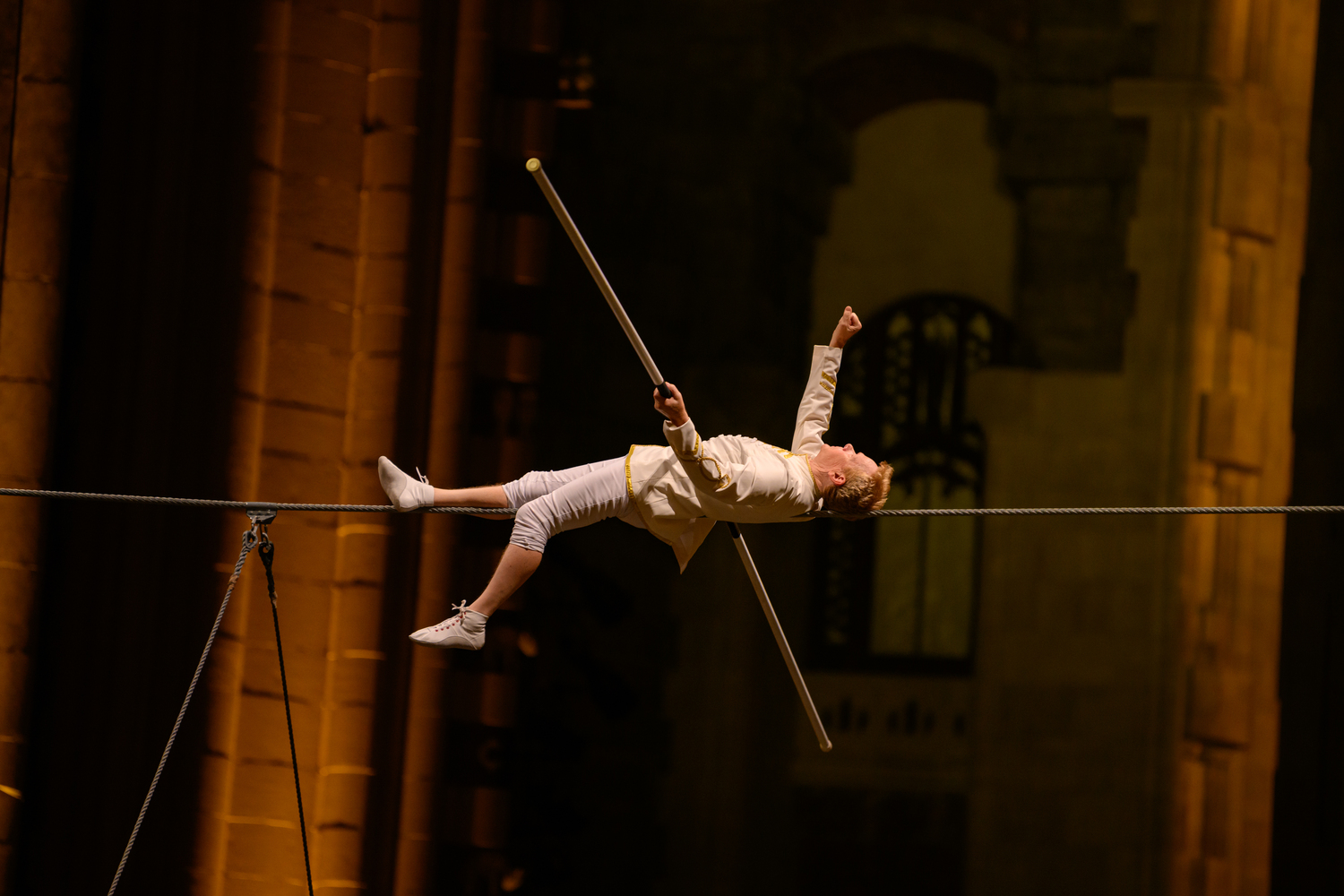 Philippe Petit lays on the wire during a performance of 