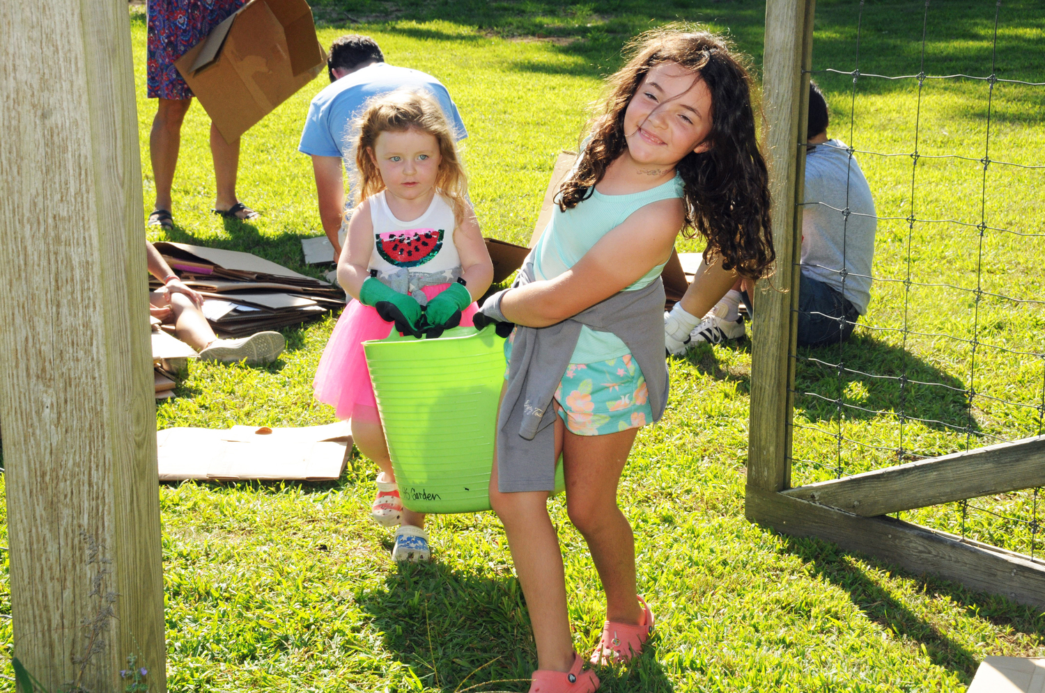 Leah and Claire Kochanasz at the East Hampton Town Historical Farm Museum on August 2 where they joined with ReWild Long Island and members of the community to restore the pollinator garden  designed by Matthew L. Lester who lost his life in 2017.      RICHARD LEWIN