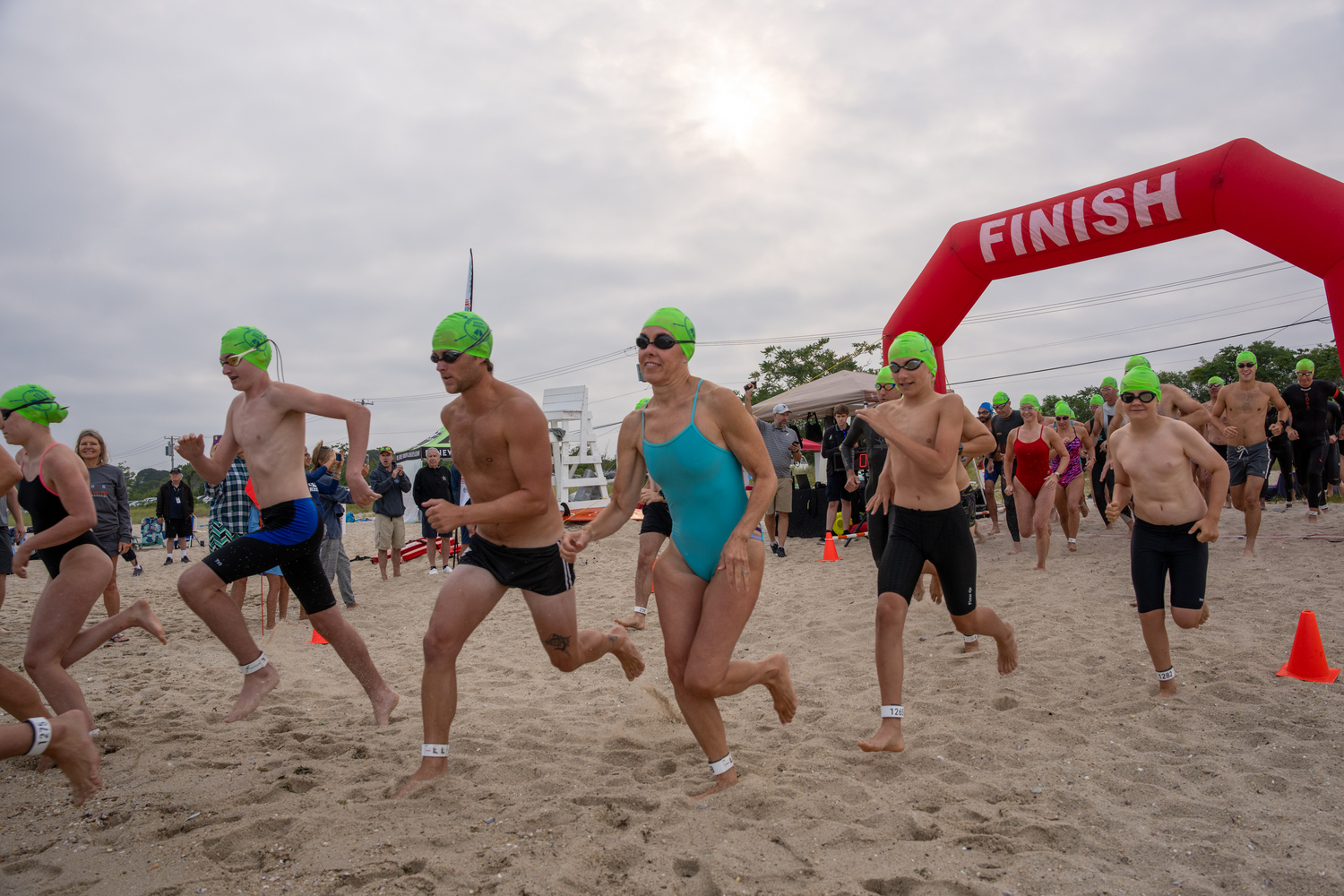 Participants head into the water at Long Beach in Sag Harbor for Saturday's swim.   RON ESPOSITO