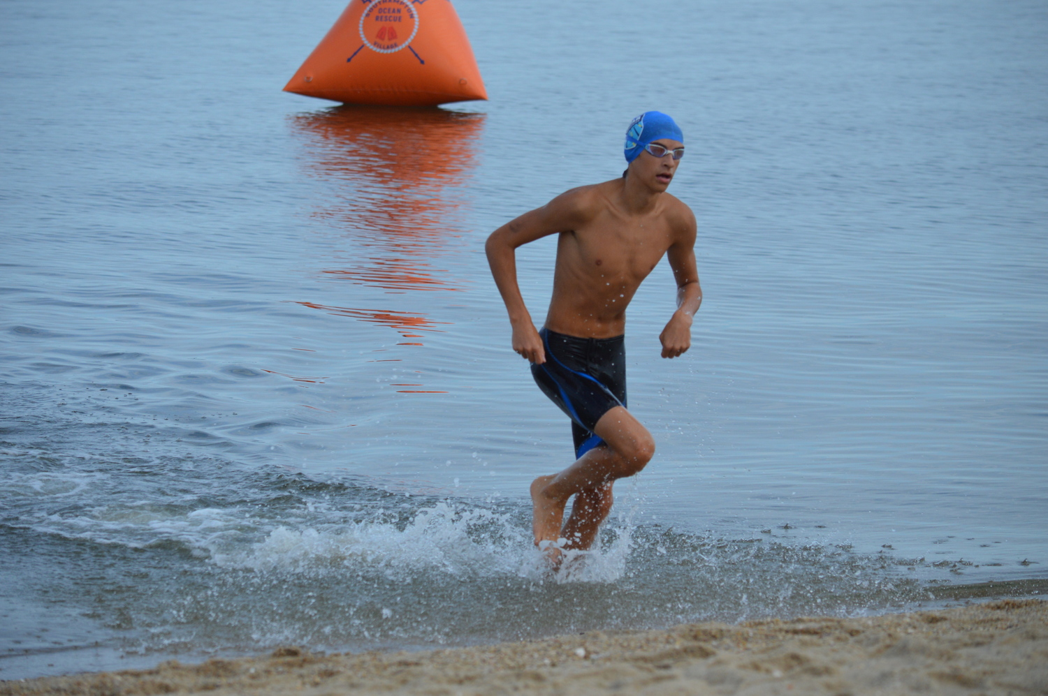 Pierson sophomore Nicky Chavez emerging from the water off Long Beach following the 1-mile swim. GAVIN MENU