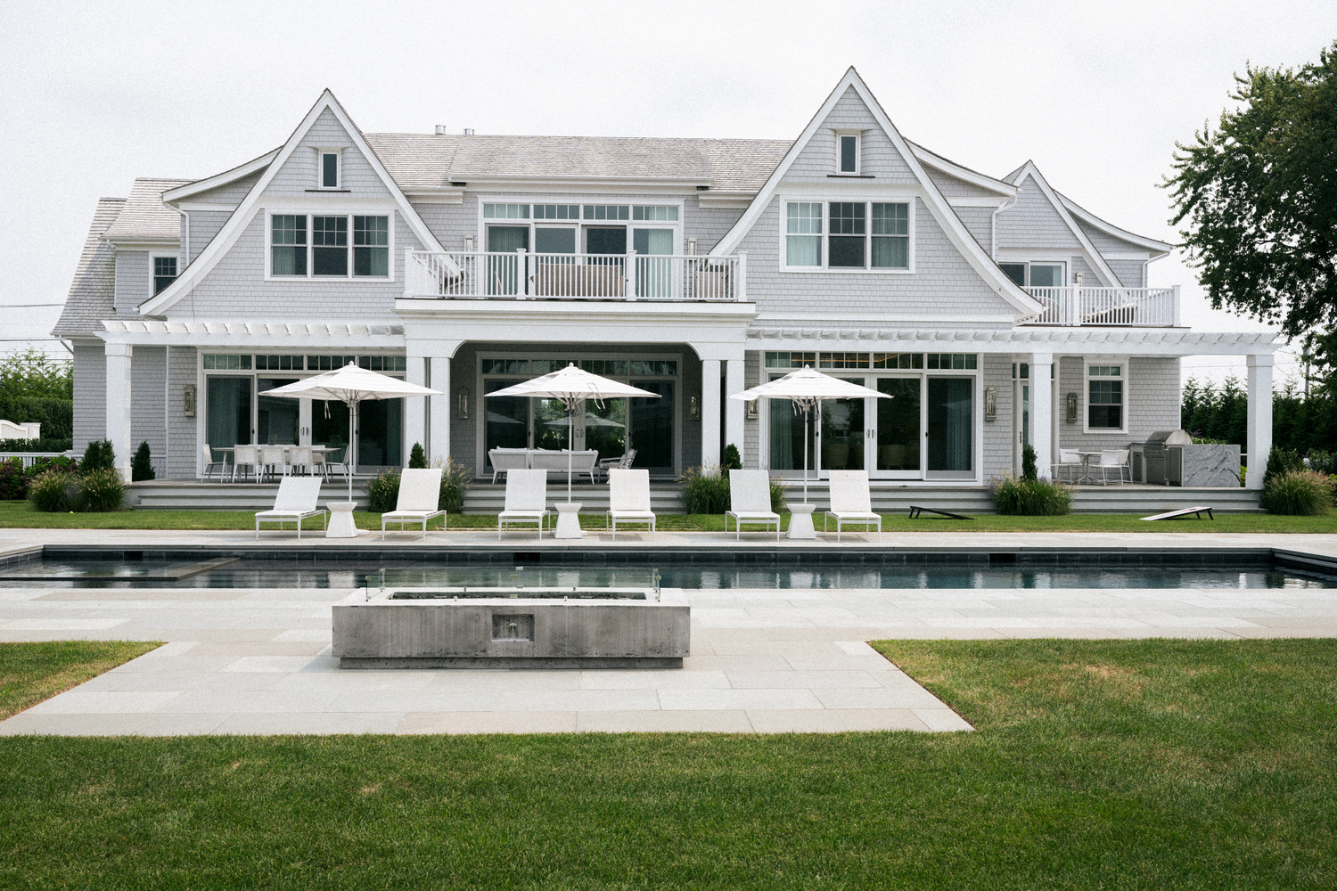 The pool grounds and the house's facade are a true homage to the Hamptons. MACRAE MARRAN