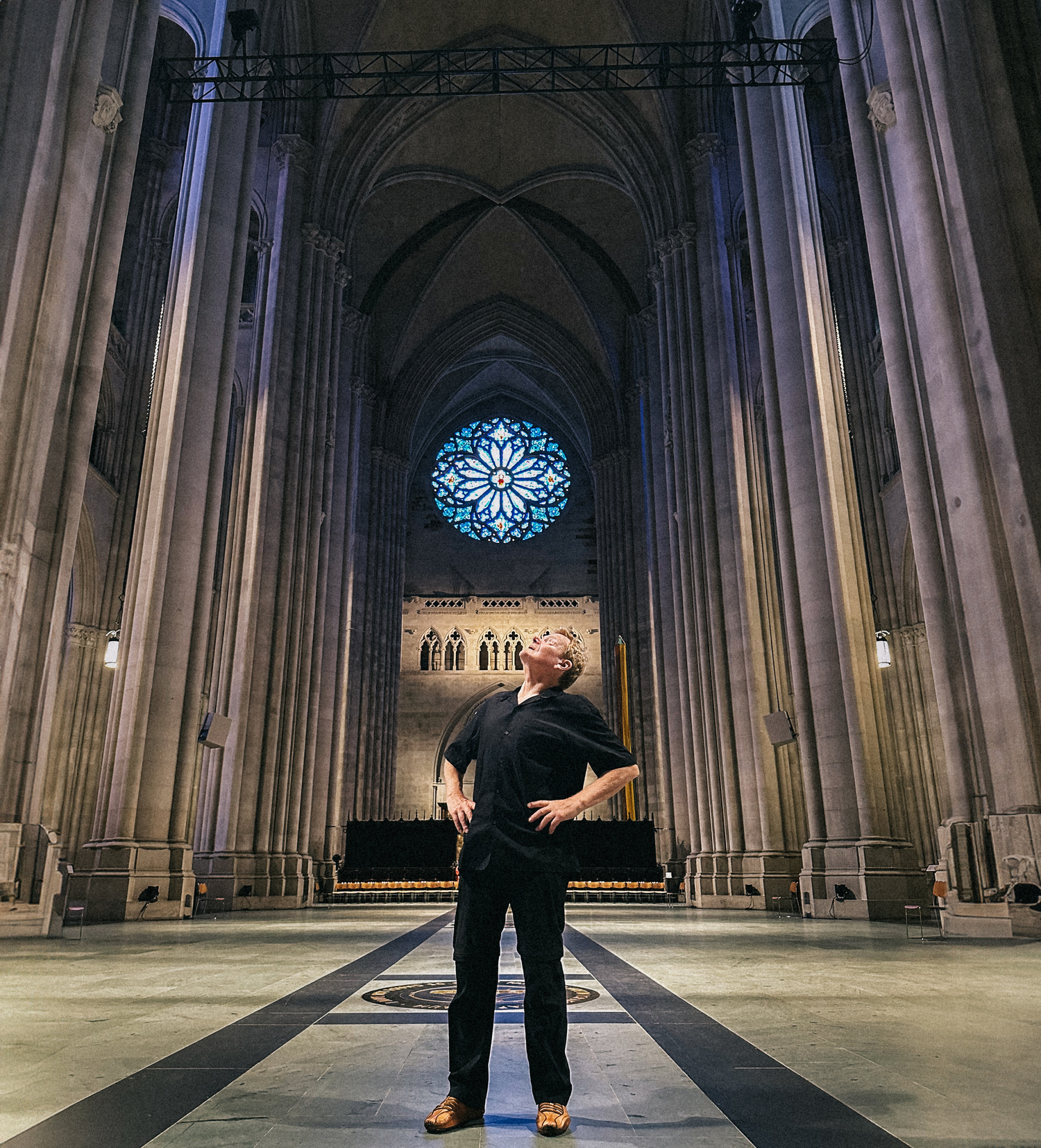 Philippe Petit gazes up at the soaring space inside The Cathedral of St. John the Divine in Manhattan where he is an artist-in-residence. VICTORIA DEARING