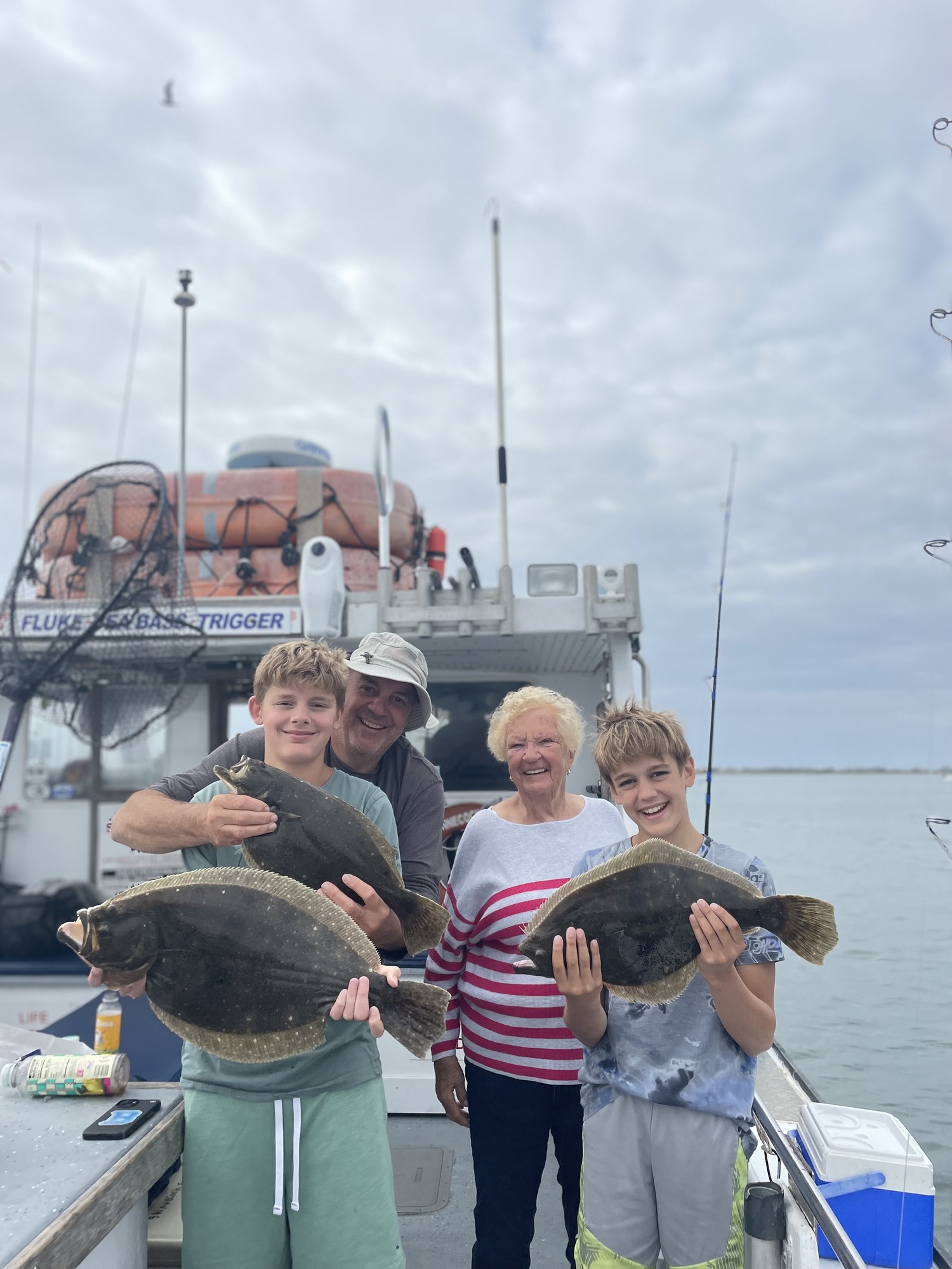 Jenny Beck and her son Claudio and grandsons Luca and Dante got in a great day of fluke fishing aboard the Shinnecock Star last week. DEENA LIPPMAN