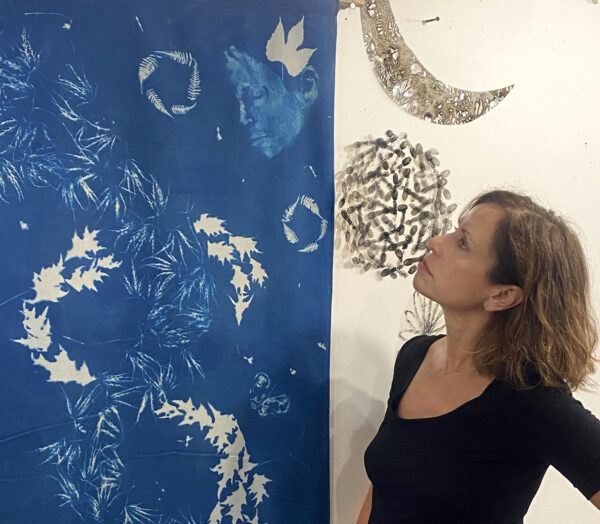 Andrea Cote in the studio with one of the cyanotype banners for her show at Bridge Gardens. COURTESY THE ARTIST