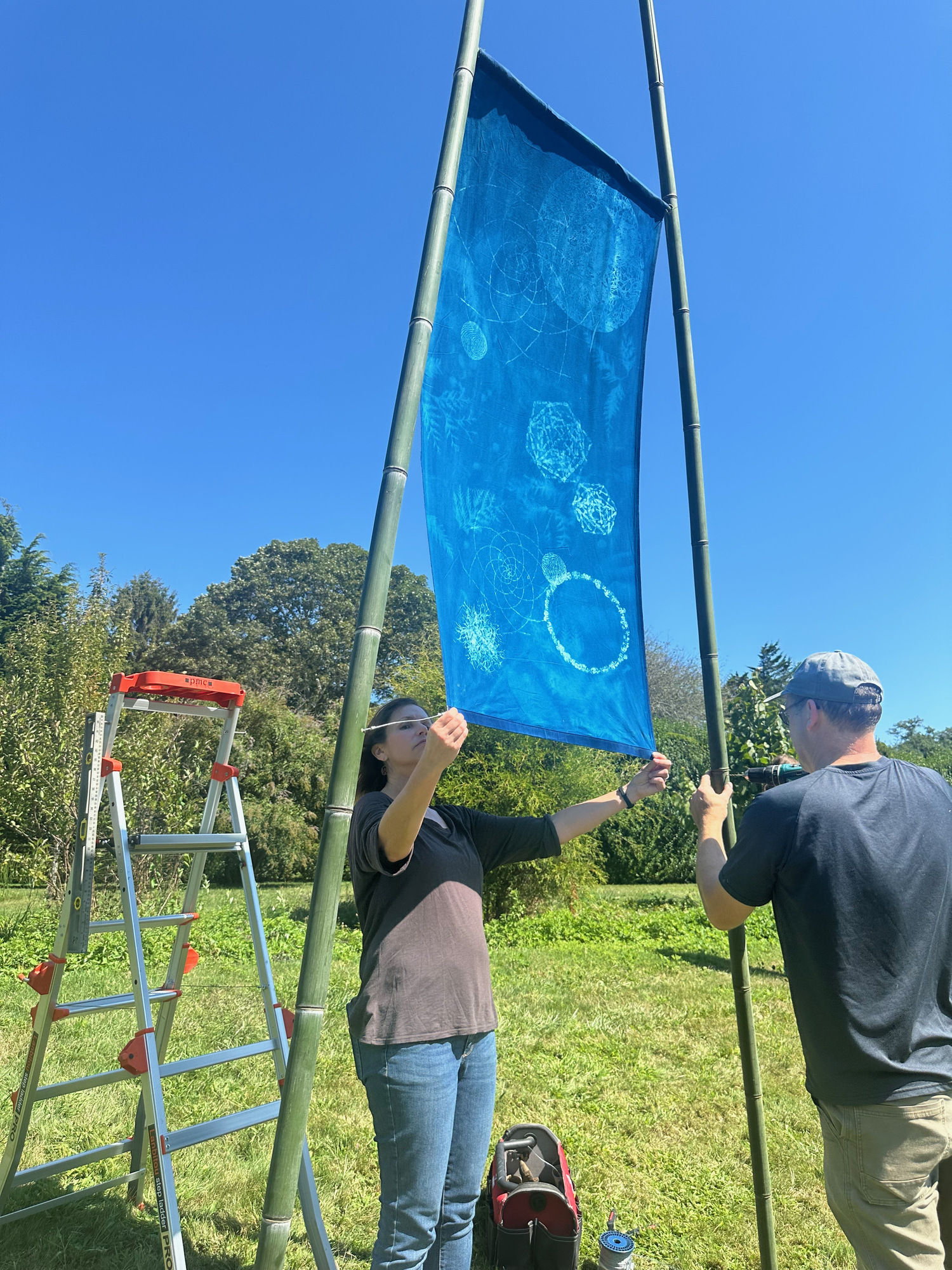 Andrea Cote and her husband Pierre install her winter solstice cyanotype at Bridge Gardens on September 9. ANNETTE HINKLE