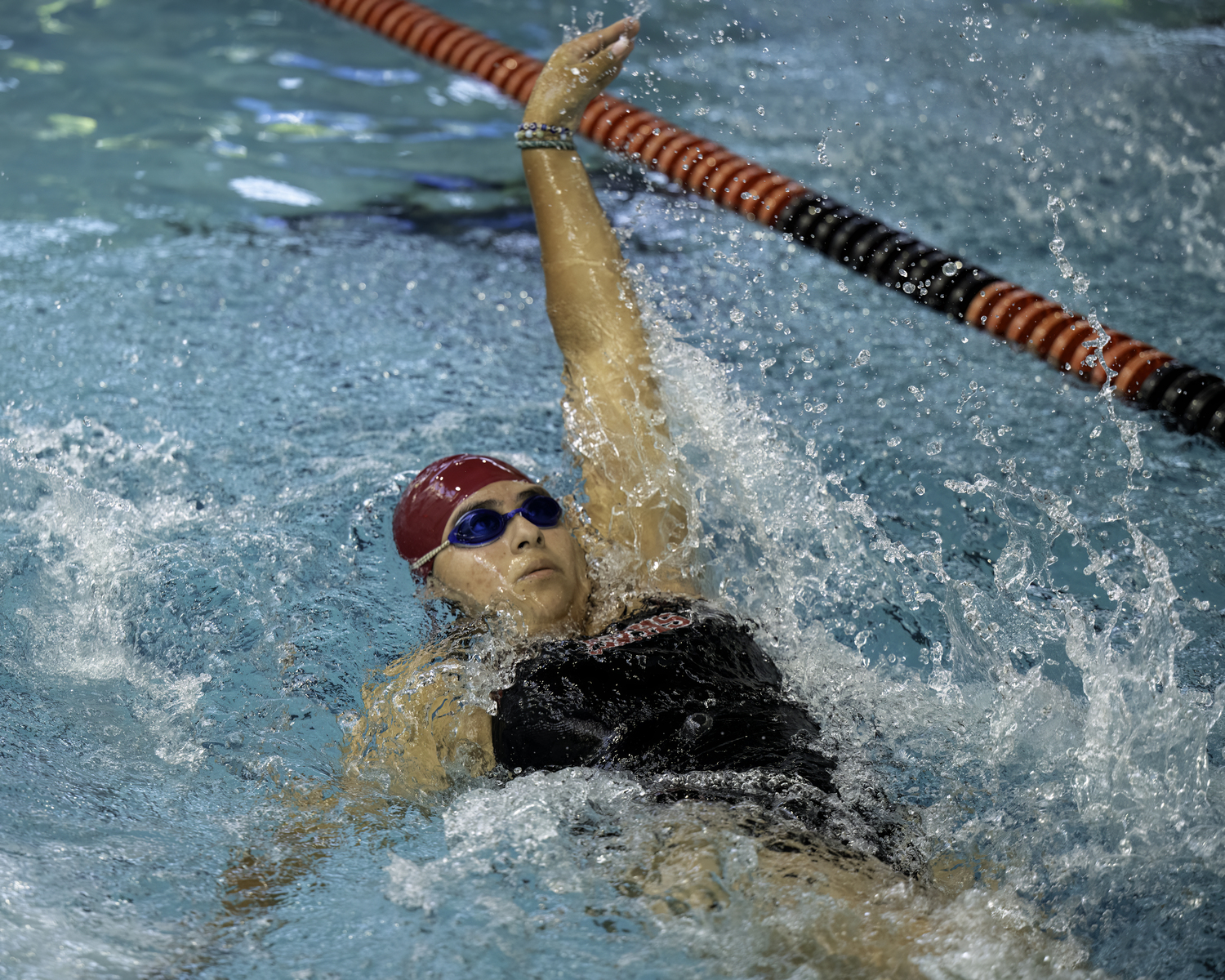 East Hampton senior Ashley Leon swims the backstroke during a meet last season. MARIANNE BARNETT