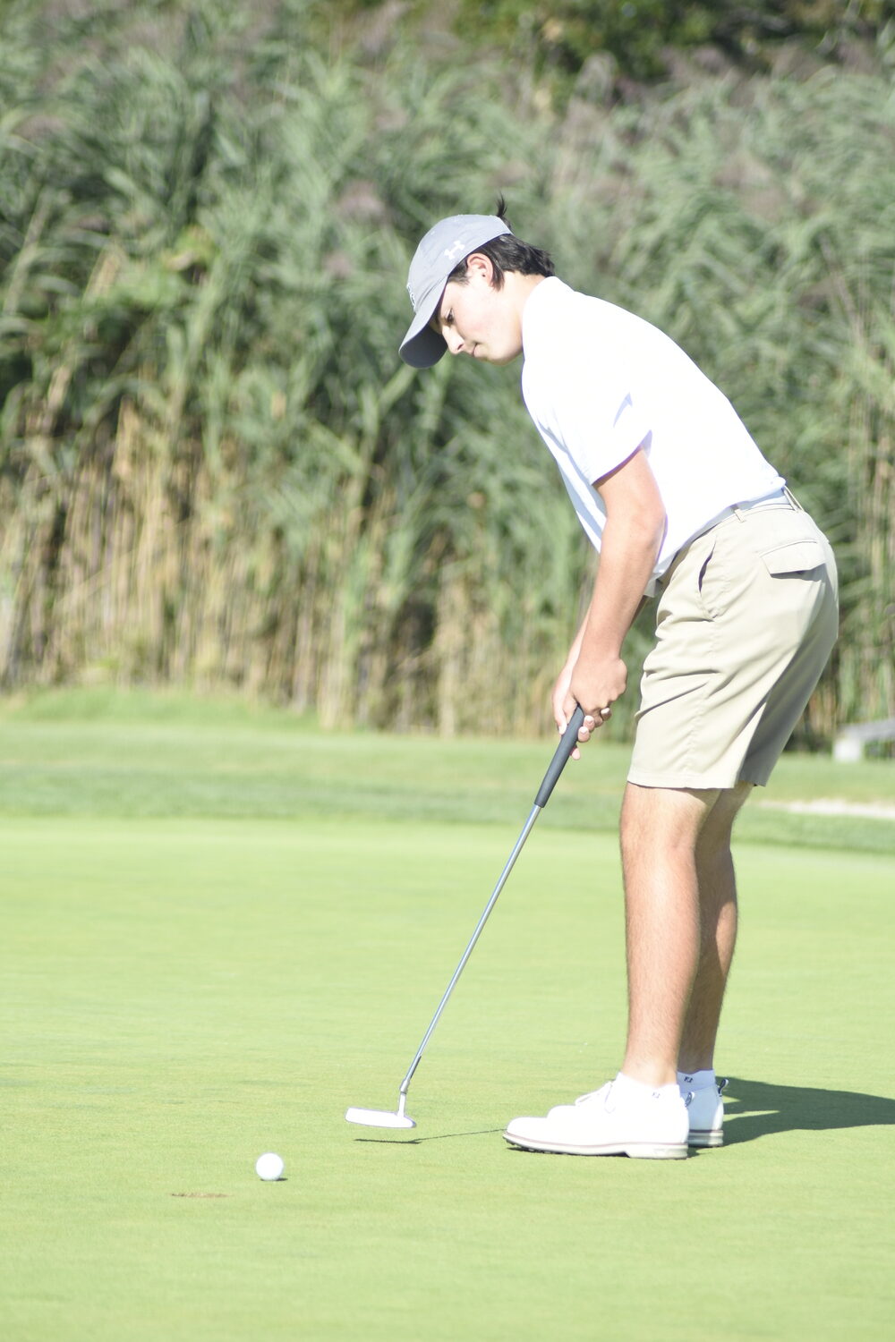 Zach Berger putts on the first hole of last week's match against East Hampton.   DREW BUDD