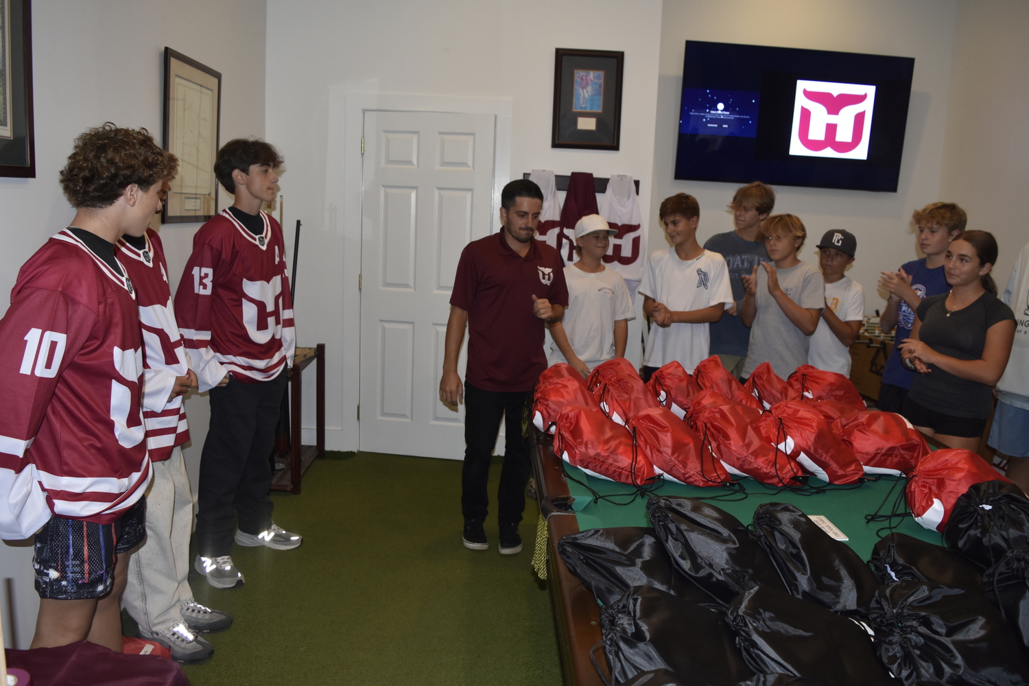 Teammates clap it up for their captains receiving their jerseys.   DREW BUDD