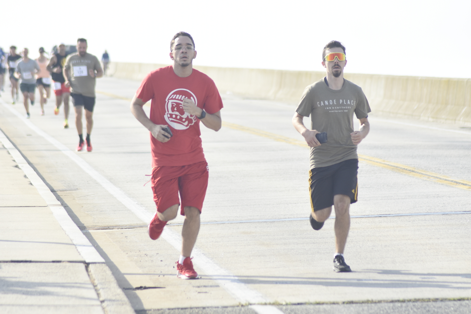 Runners head over Ponquogue Bridge in Hampton Bays on Saturday morning.   DREW BUDD