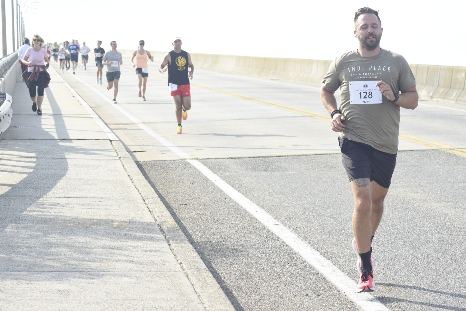 Matthew Kristan and the rest of the runners head over Ponquogue Bridge Saturday morning.  DREW BUDD