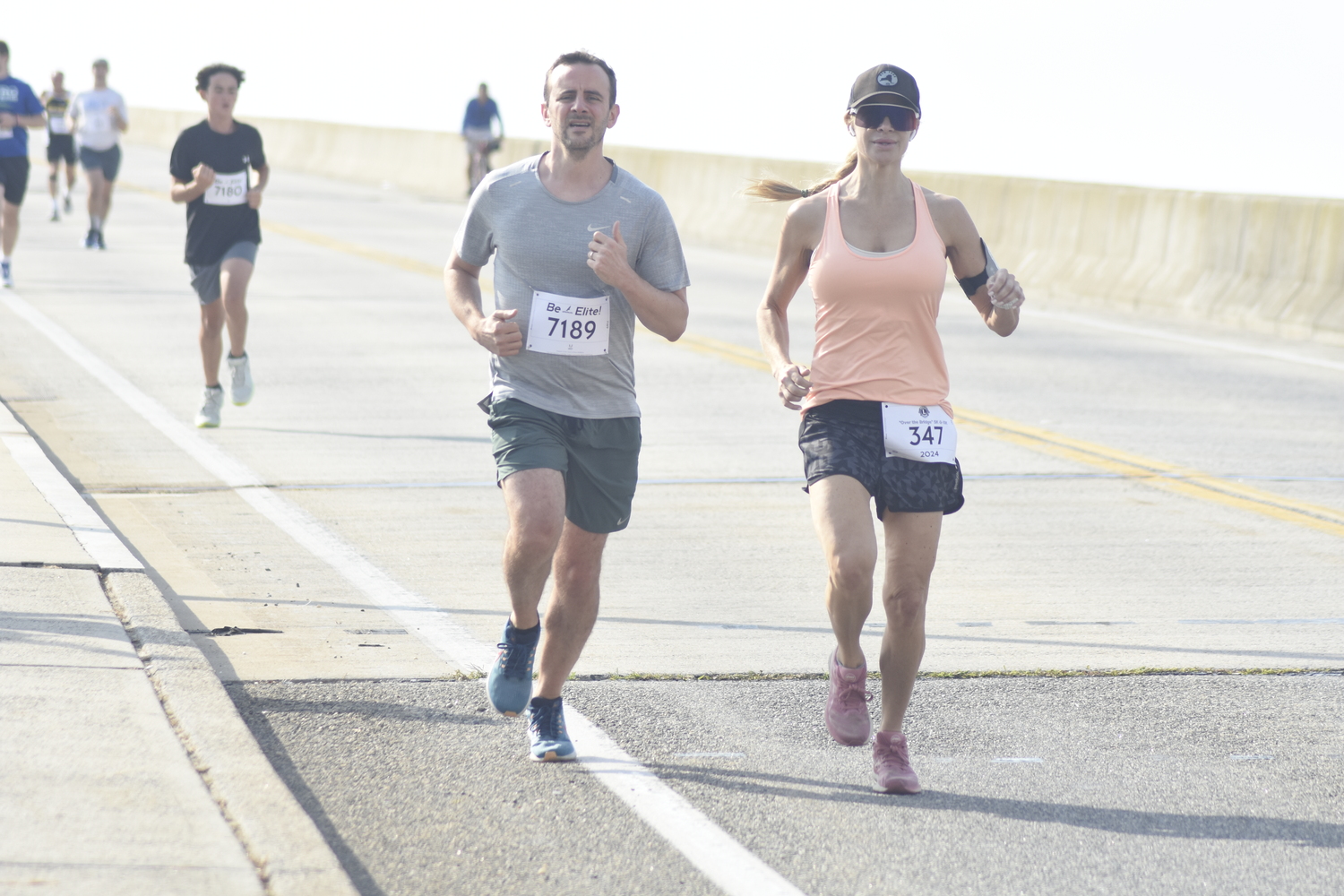 Adam Rotberg, left, and Sasha Kemnitzer heading over the Ponquogue Bridge on Saturday morning.  DREW BUDD