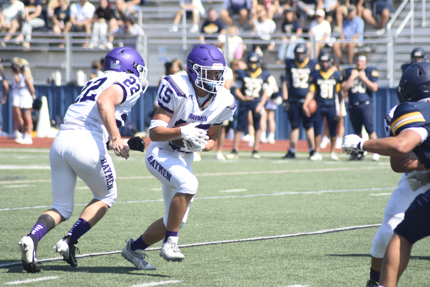 Sophomore Brayden Talmage takes a handoff from senior Nate Donahue.   DREW BUDD