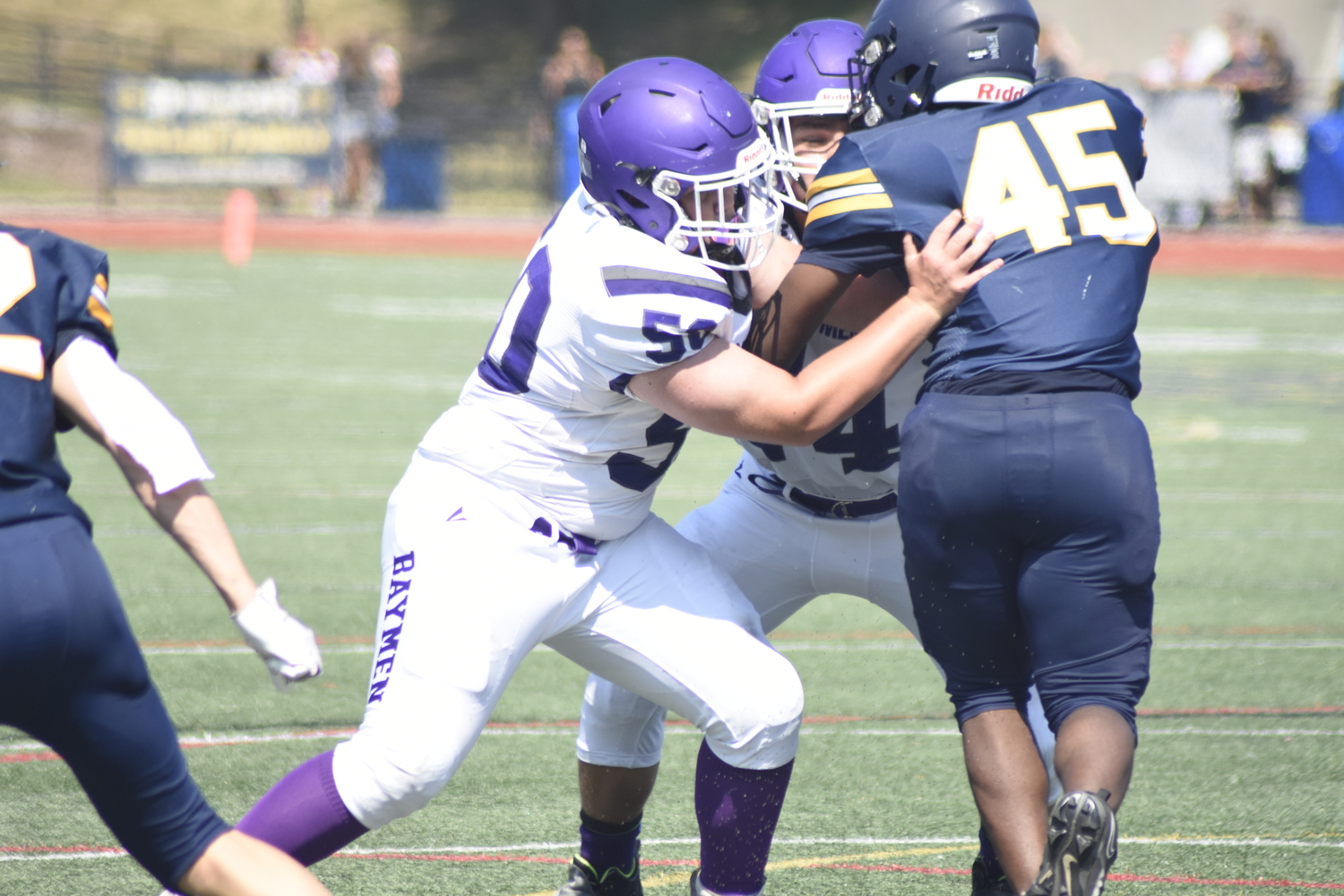 Baymen Colton Shay, left, and Gabriel DiFrancesco double team a Shoreham-Wading River defender.   DREW BUDD