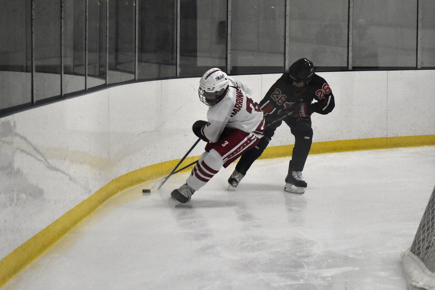 Hunter Harrington plays the puck back along the boards.   DREW BUDD