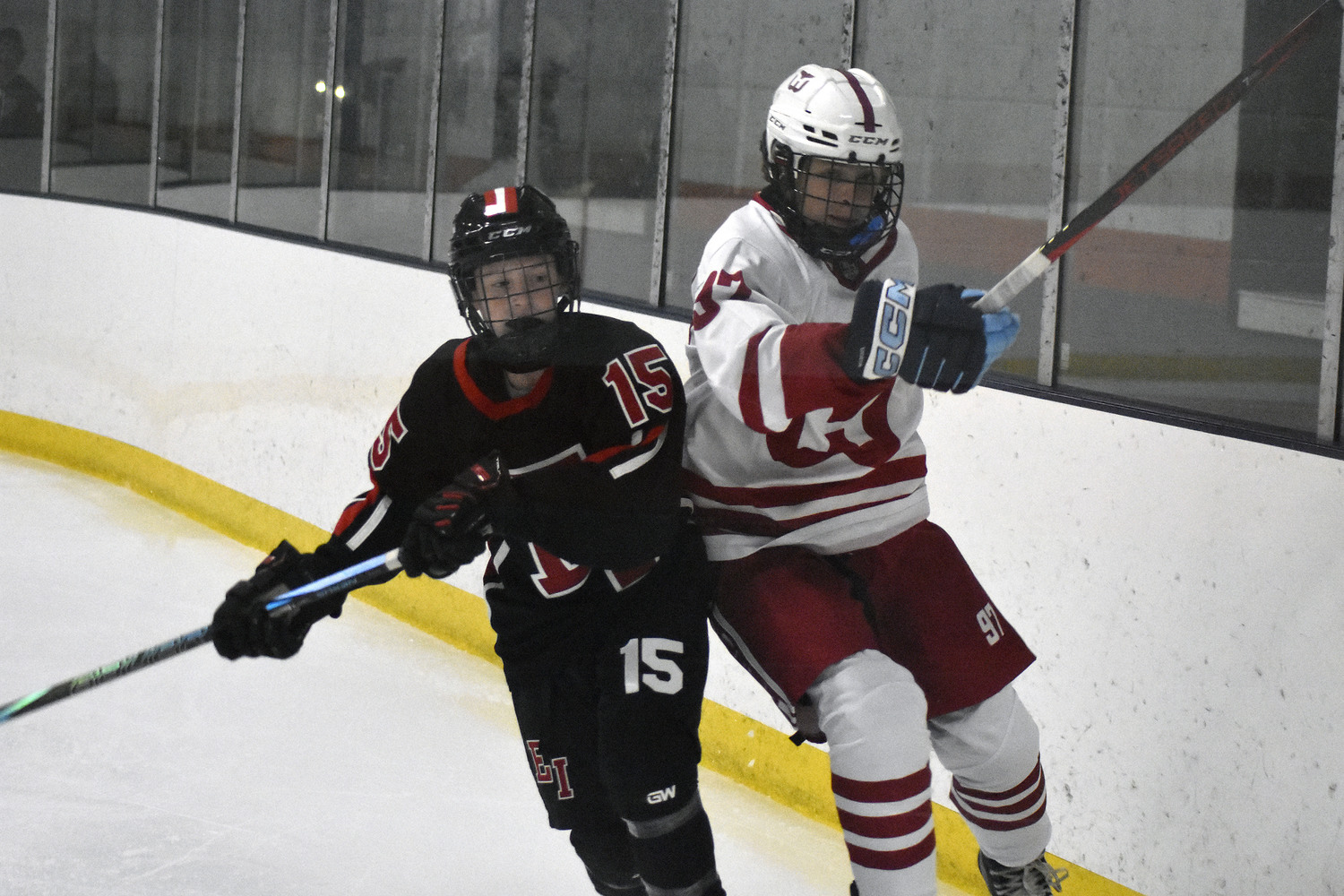 Aidan D'Angelo and an East Islip player bump one another behind the Whalers' net.  DREW BUDD