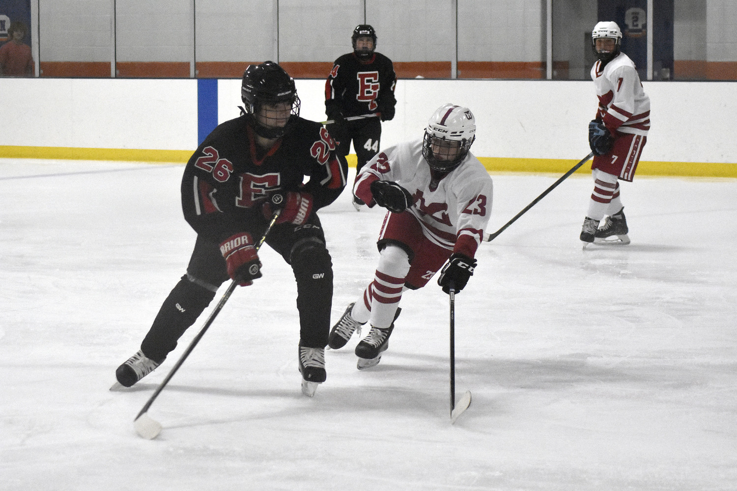 Mateo Vergara tries to get his stick in the shooting lane of an East Islip player.   DREW BUDD