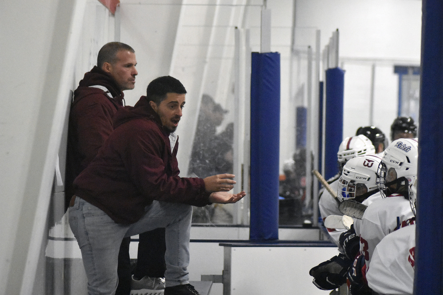 Coaches Bryan Wish and Brendan Goldstein talk to their players during an intermission.   DREW BUDD