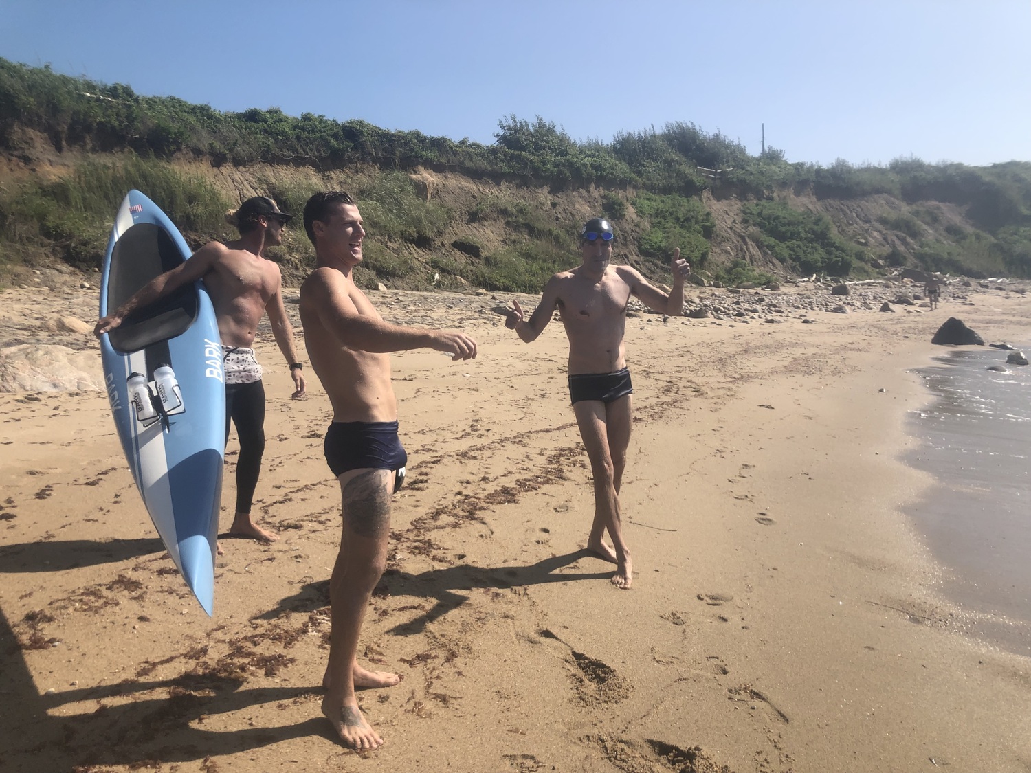 From left, Nick Stevens, Drew Harvey and Michal Petrzela celebrate after reaching Block Island. COURTESY DAWGPATCH BANDITS