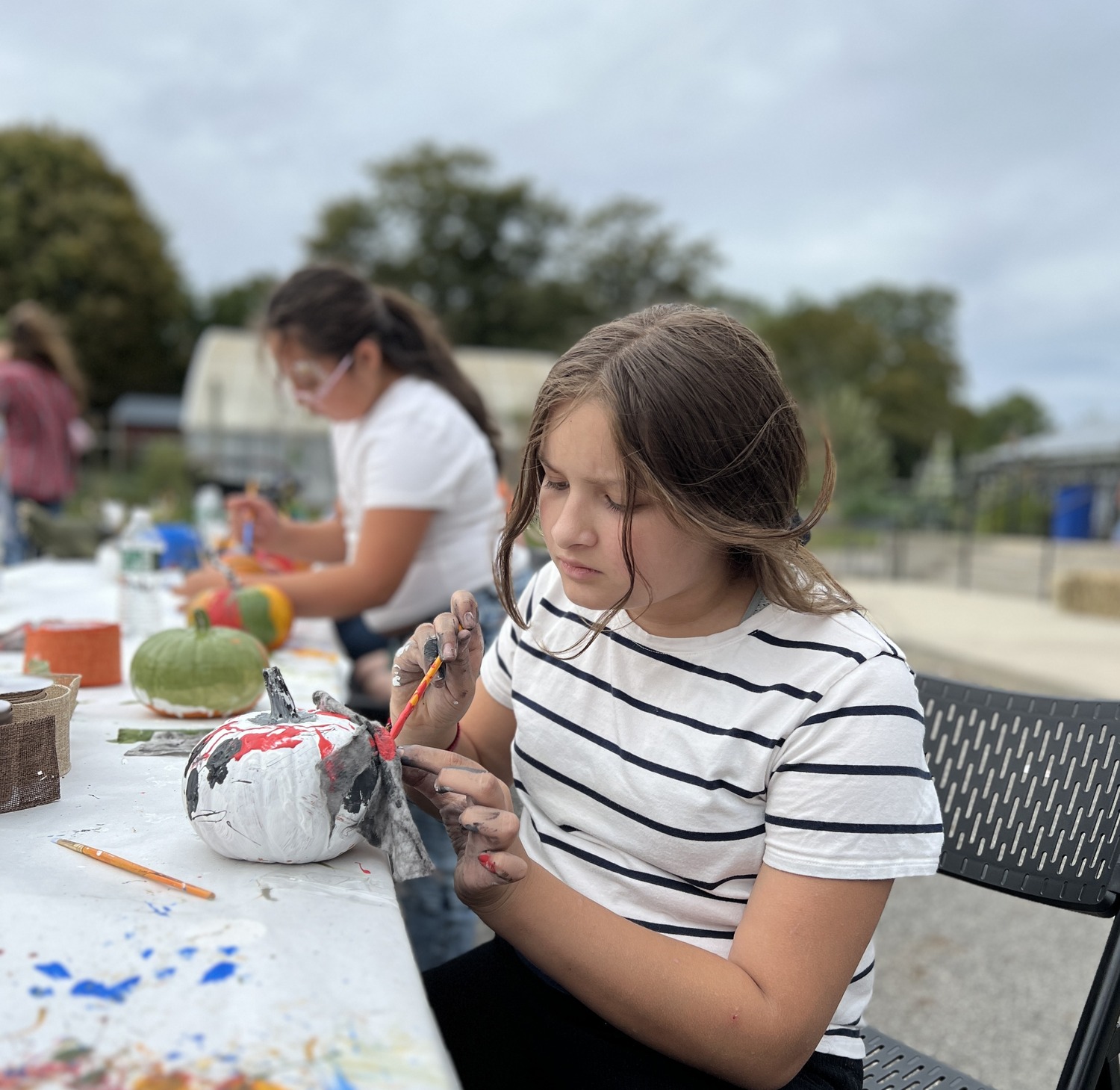 The Bridgehampton School continued its annual tradition this weekend by hosting a
Fall Festival. Sponsored by the school’s 21st Century Community Learning Center grant,
students and families enjoyed music, face painting, pumpkin decorating and food. Sixth-grader Ariana LaSerna decorated a pumpkin. COURTESY BRIDGEHAMPTON SCHOOL DISTRICT