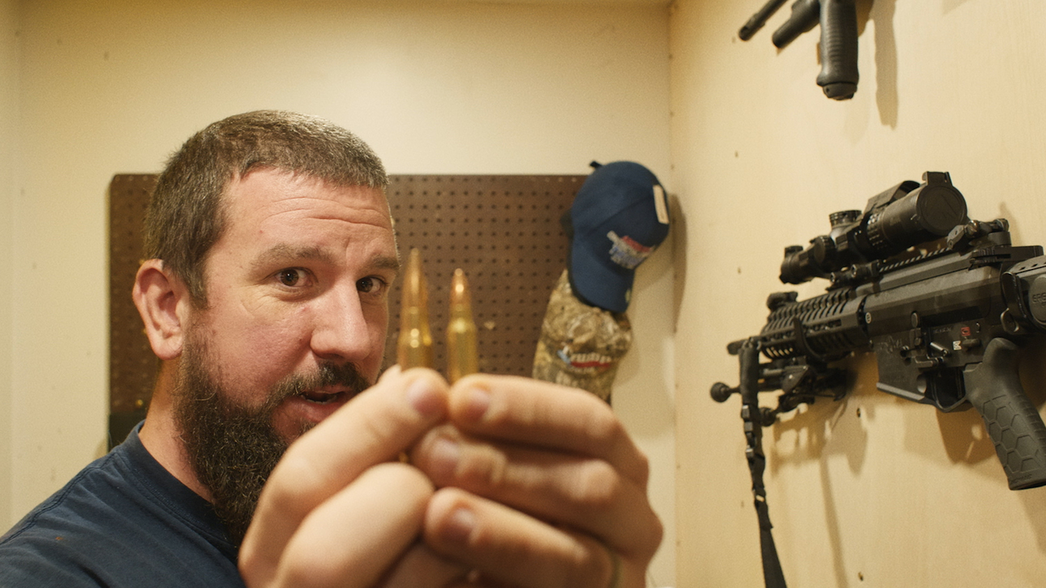 Right-wing activist Chris Quaglin compares bullet caliber sizes in Michael Premo's documentary 