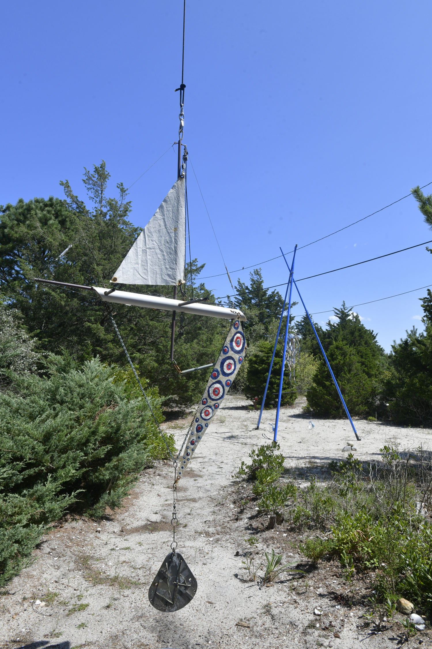 The front yard could be considered an outdoor art gallery where Dixon’s fish mobiles sway gently with the wind. The collection of colorful objects represent the marine life that Dixon craves, from fish to sailboats.  DANA SHAW