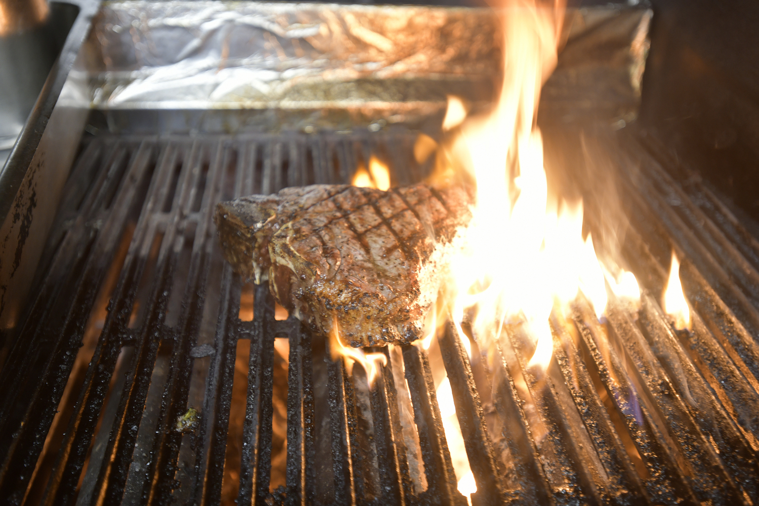 A porterhouse on the grill at the Old Stove Pub.  DANA SHAW