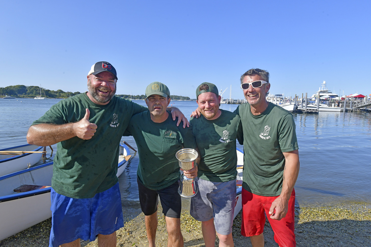 The John K. Ott Men's Whaleboat team; Mike Daniels, Gene Garypie, John Cottrell and Dave Schroeder, with the Championship trophy.    DANA SHAW