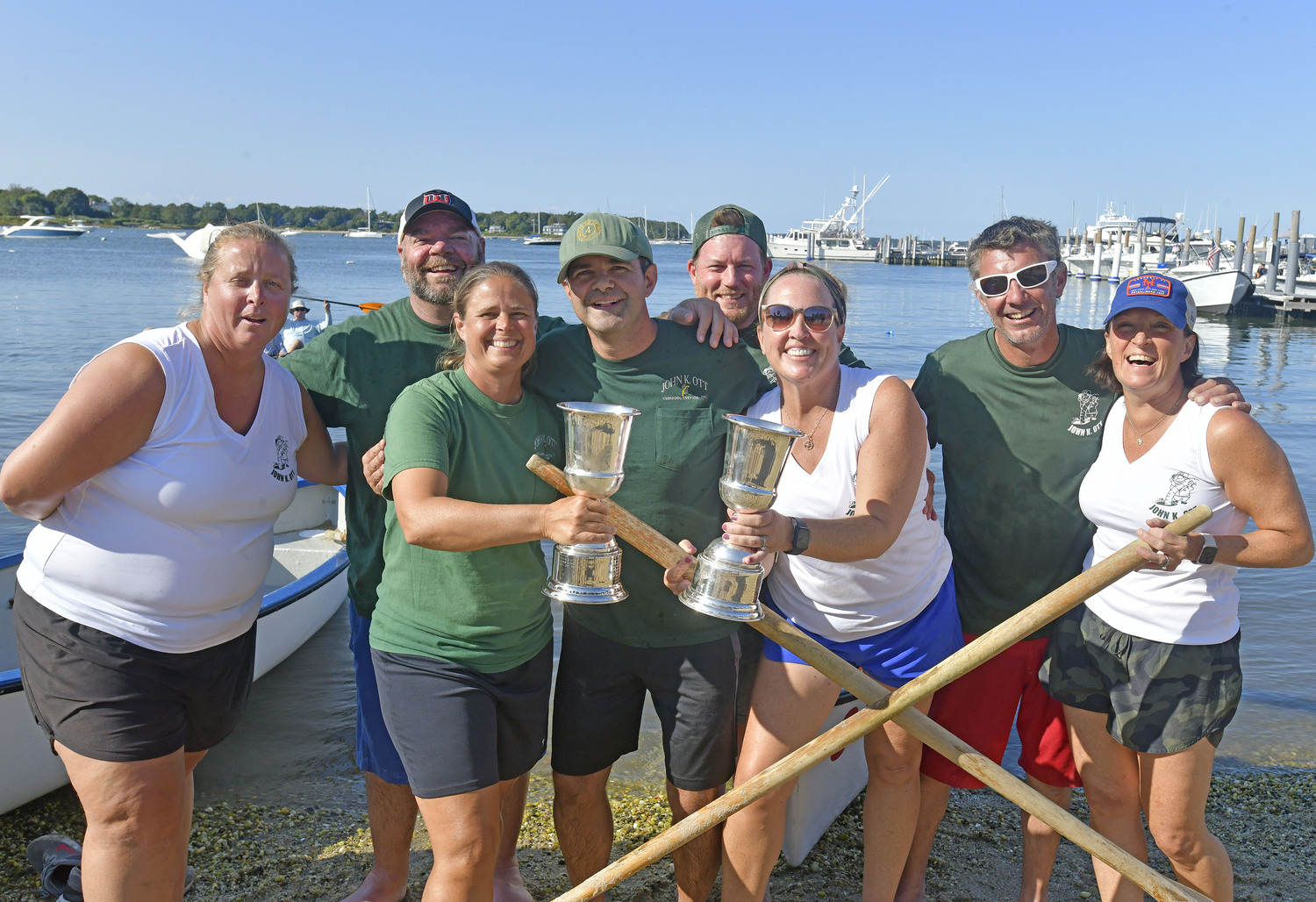 The John K. Ott Men's and Women's Whaleboat teams with their Championship trophies.    DANA SHAW