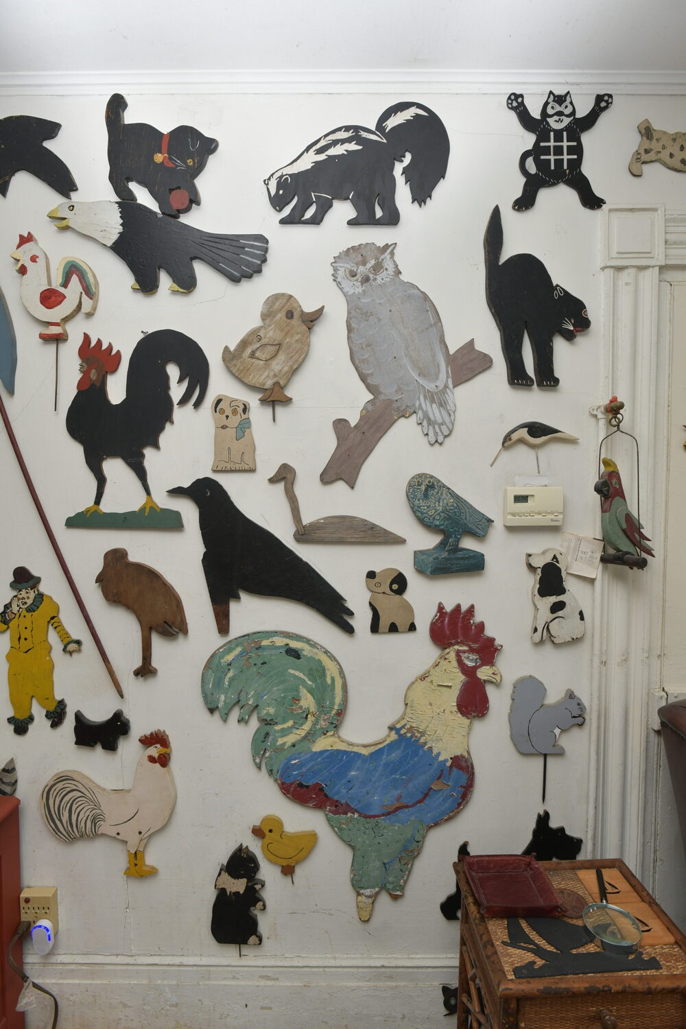 Items from Joan Tyor Carlson's  extensive collection of small painted wooden cut-outs of figures and signs.   DANA SHAW