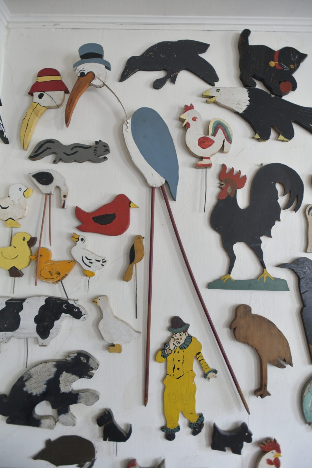 Items from Joan Tyor Carlson's  extensive collection of small painted wooden cut-outs of figures and signs.   DANA SHAW