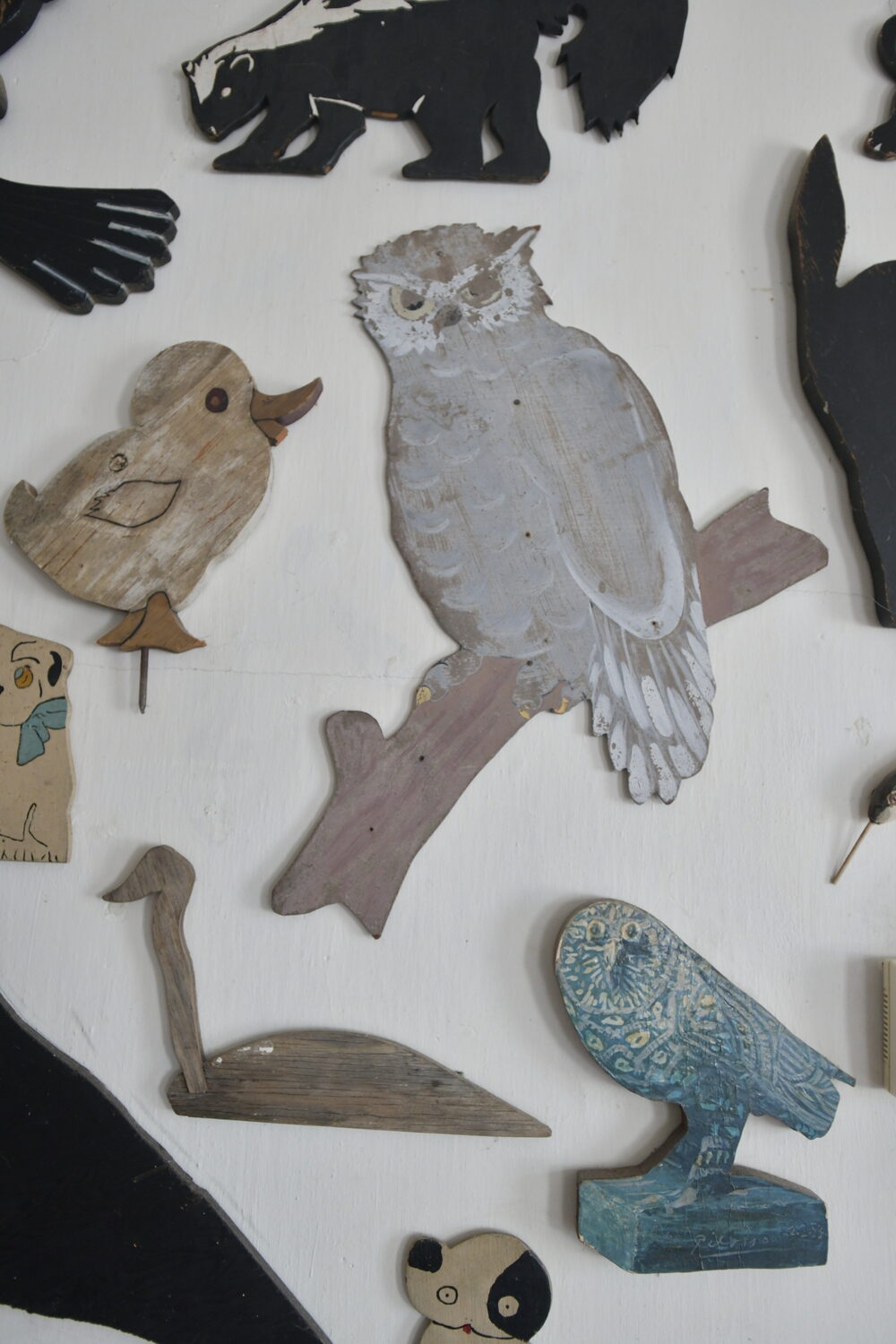 Items from Joan Tyor Carlson's  extensive collection of small painted wooden cut-outs of figures and signs.   DANA SHAW