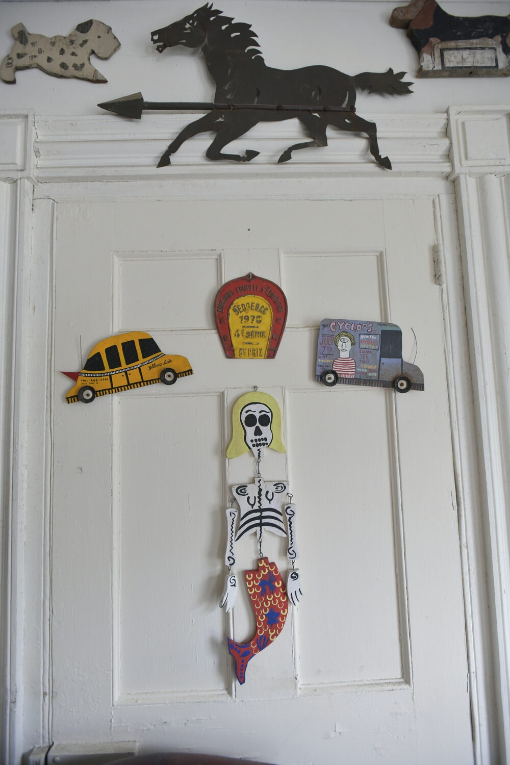 Items from Joan Tyor Carlson's  extensive collection of small painted wooden cut-outs of figures and signs.   DANA SHAW