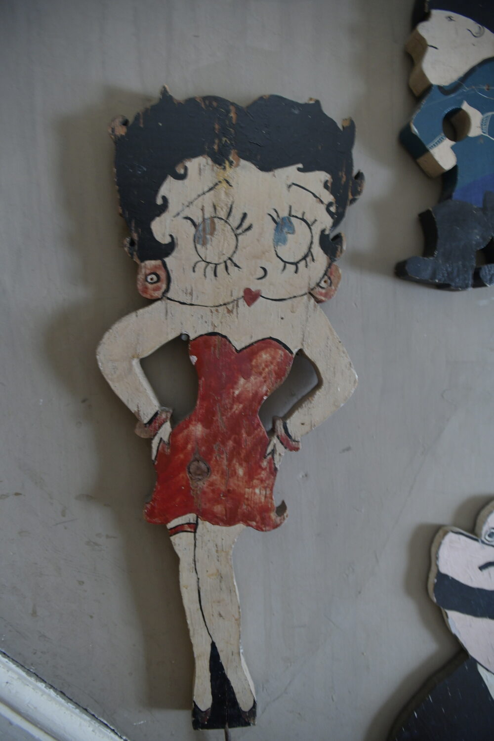 Items from Joan Tyor Carlson's  extensive collection of small painted wooden cut-outs of figures and signs.   DANA SHAW