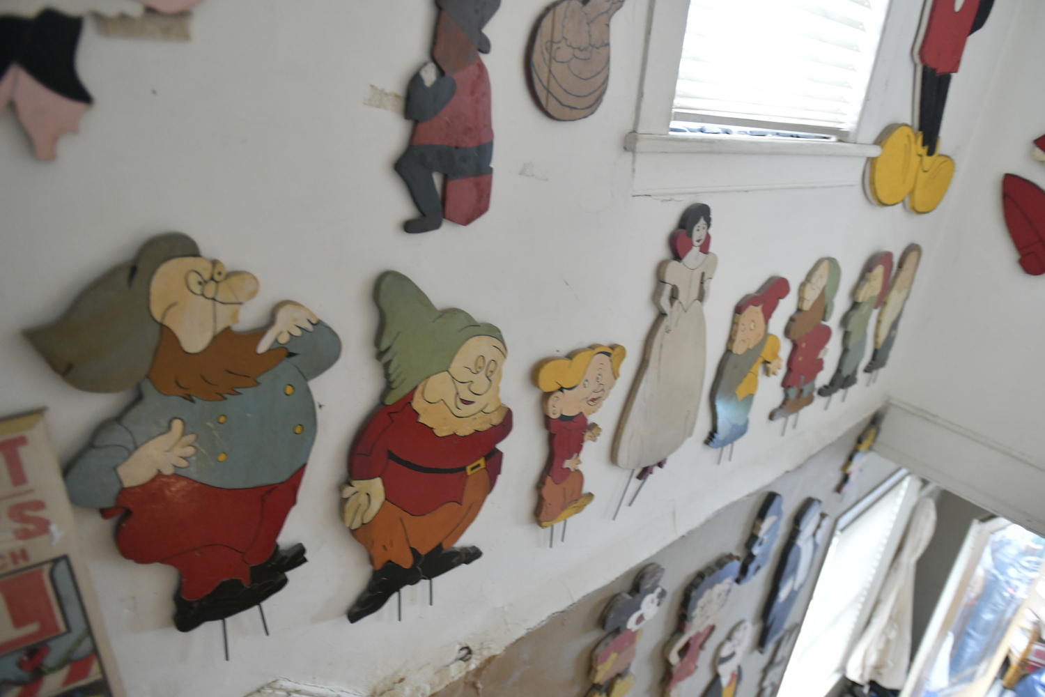 Items from Joan Tyor Carlson's  extensive collection of small painted wooden cut-outs of figures and signs.   DANA SHAW