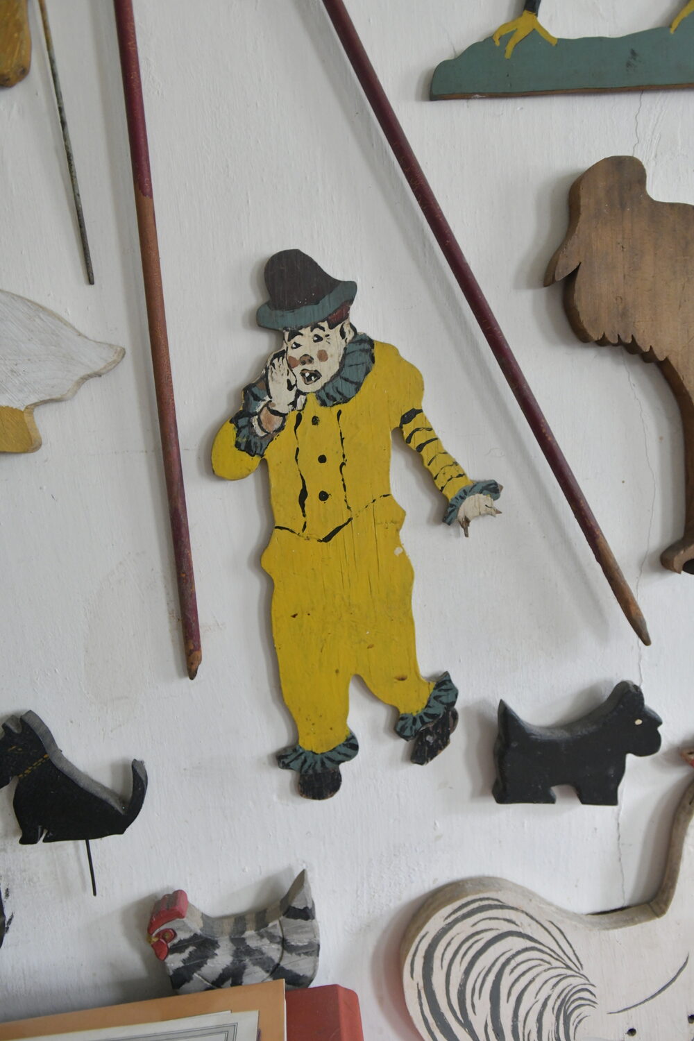 Items from Joan Tyor Carlson's  extensive collection of small painted wooden cut-outs of figures and signs.   DANA SHAW