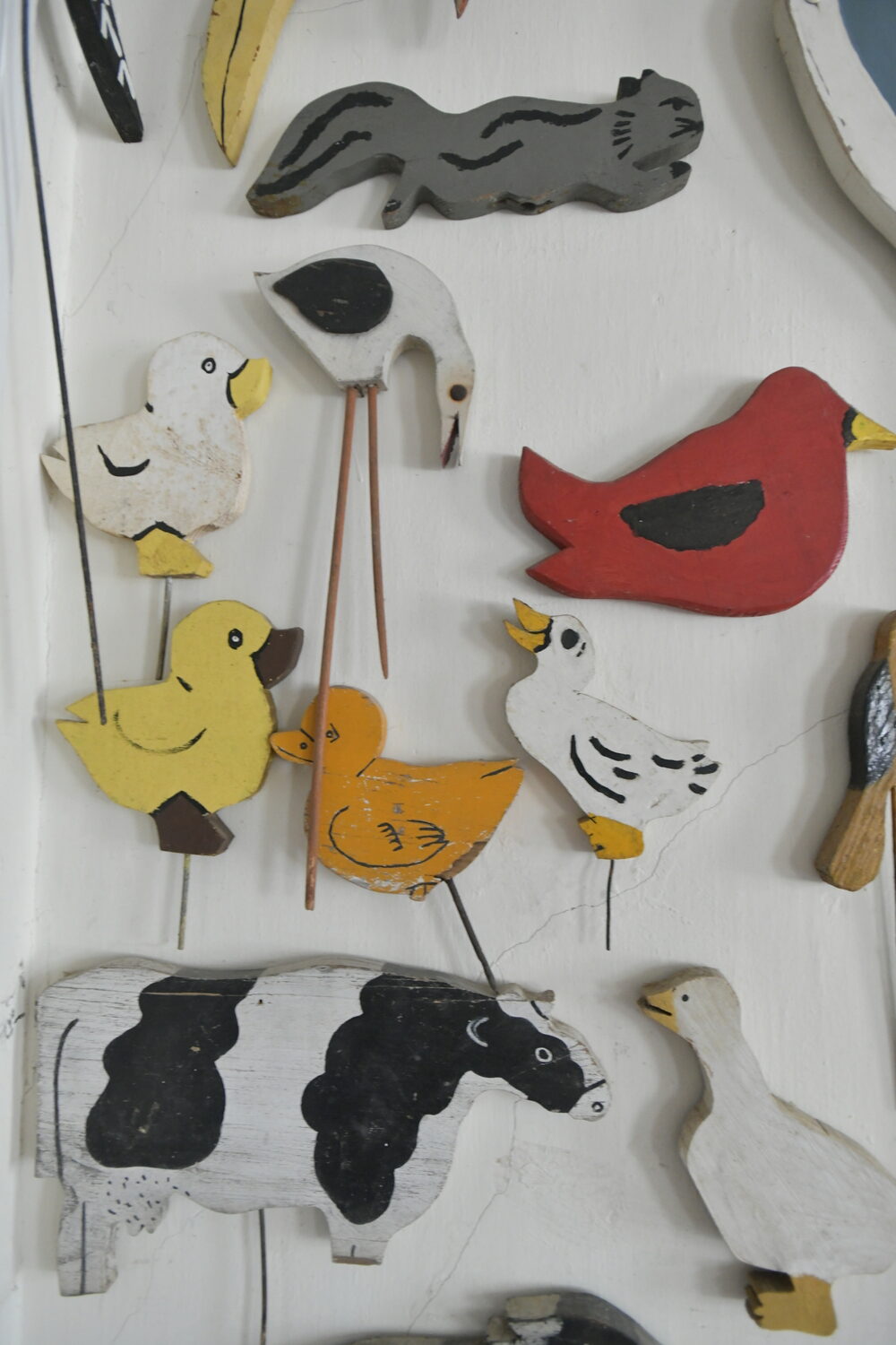 Items from Joan Tyor Carlson's  extensive collection of small painted wooden cut-outs of figures and signs.   DANA SHAW