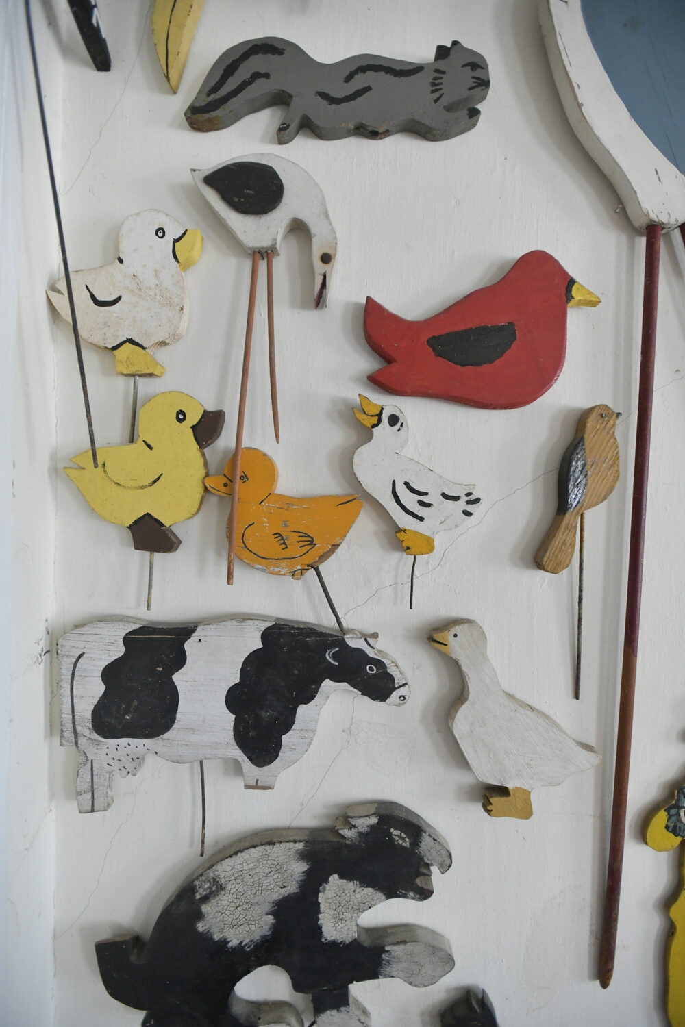 Items from Joan Tyor Carlson's  extensive collection of small painted wooden cut-outs of figures and signs.   DANA SHAW